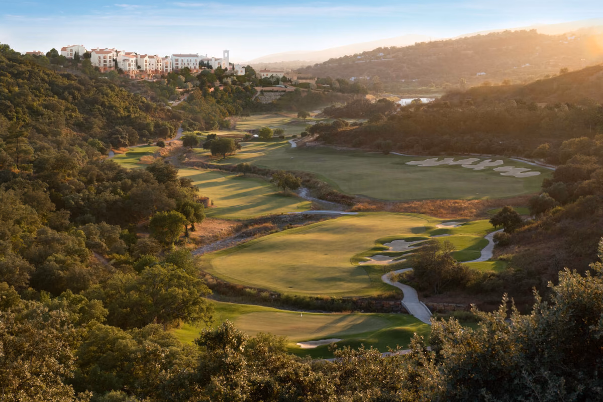 Elevated sunset view over Ombria Golf’s river valley holes